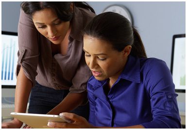 Two women looking at a tablet computer.