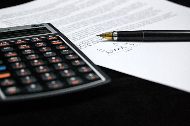 A calculator on a document, representing financial planning for signature loans. how much money can you get on a signature loan.